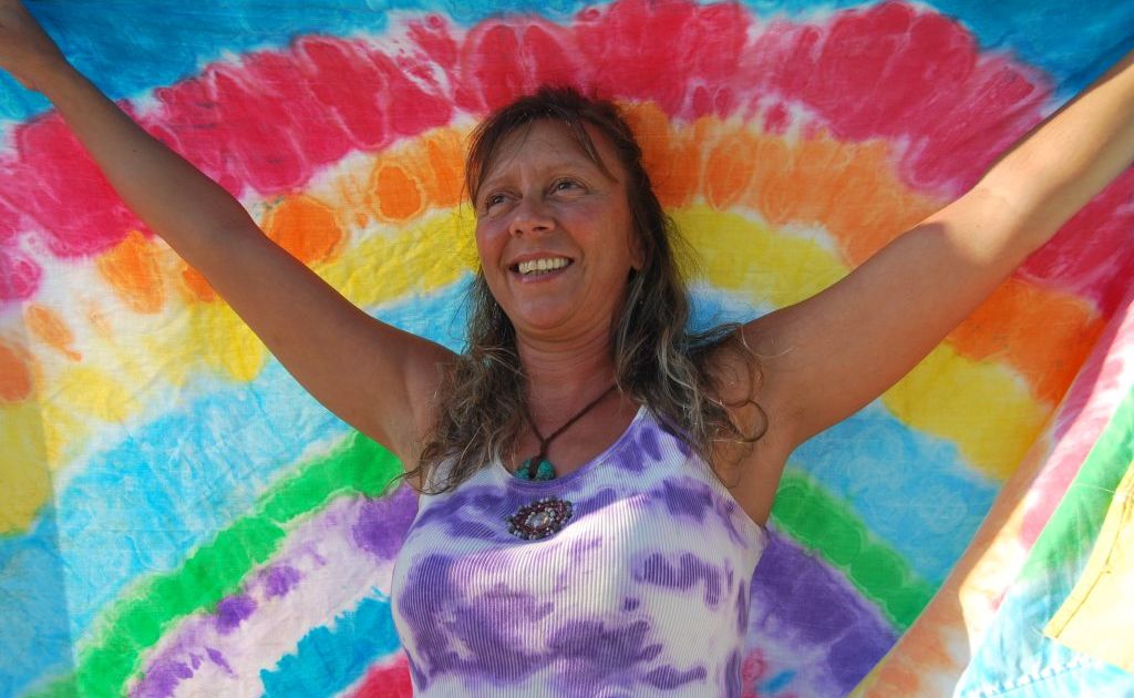 Gina Mirello with one of her spectaular tie-dyed works. Gina Mirello with one of her spectaular tie-dyed works.